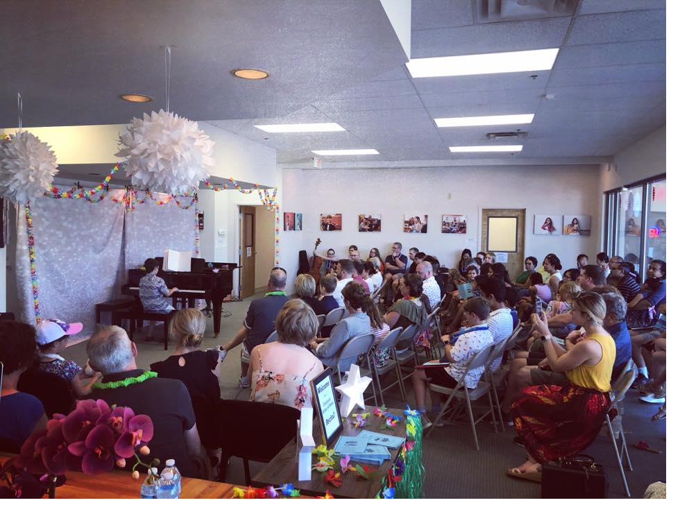 CSM recital with families watching a student perform